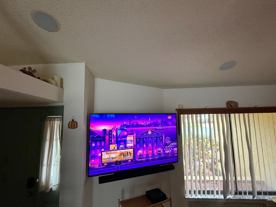 65 inch TV with Sonos soundbar, Amp, sub, and in-ceiling speakers — no visible wires