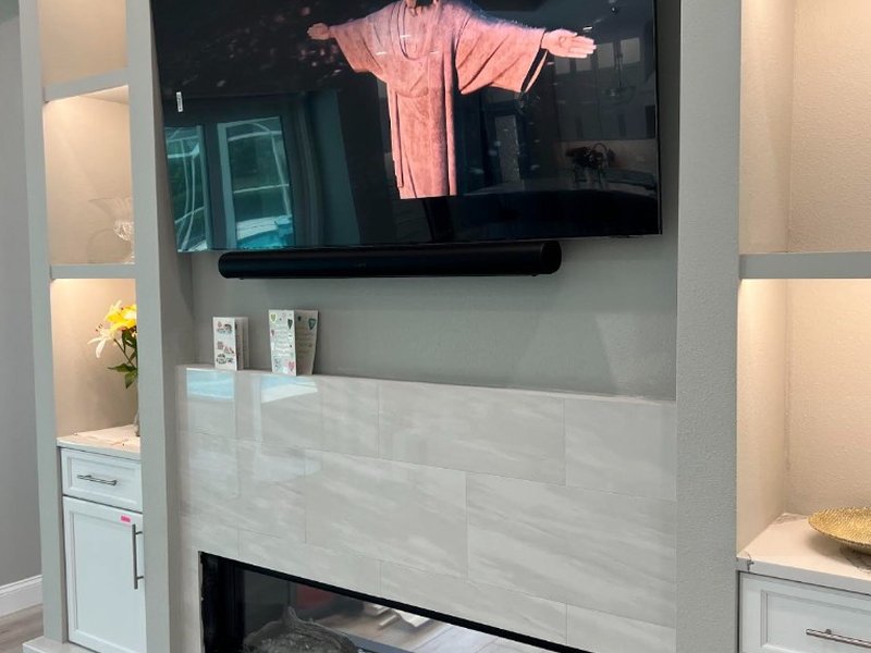 TV and Soundbar Above Marble Fireplace